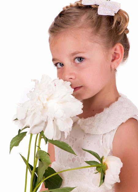 Happy little girl giving peony flowers on white background