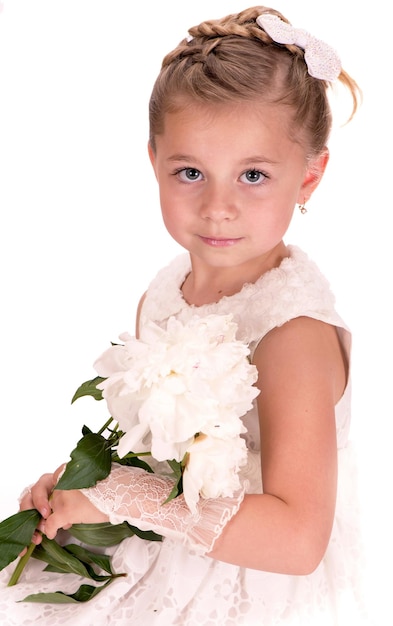 Foto bambina felice che dà fiori di peonia su sfondo bianco