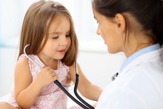 Happy little girl at  health exam at doctor office. Medicine and health care concept