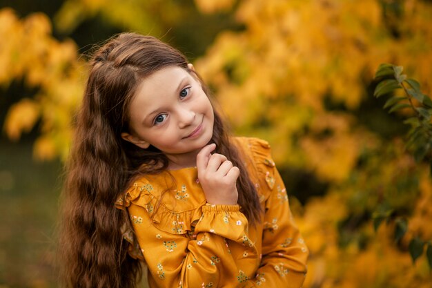 Happy little girl in the park in autumn