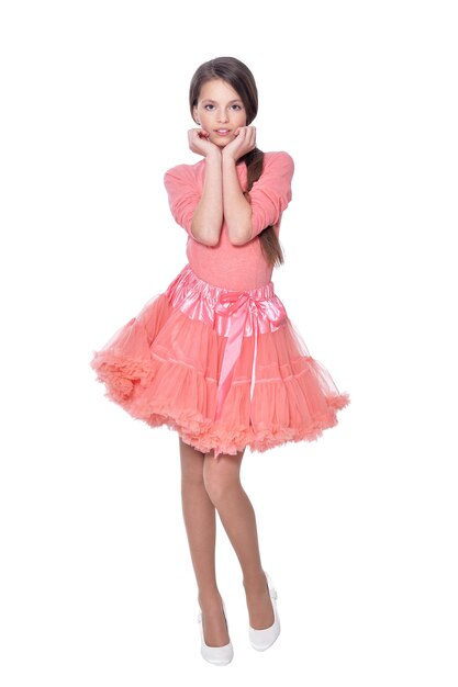 Happy little girl in pink dress posing isolated on white background