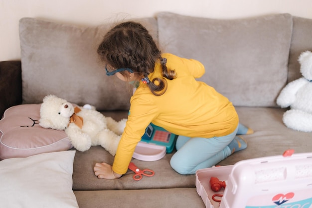 Happy little girl playing doctor in her room cute three year old girl spend time playing girls