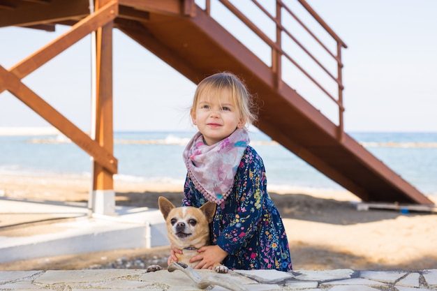 Happy little girl playing with dog