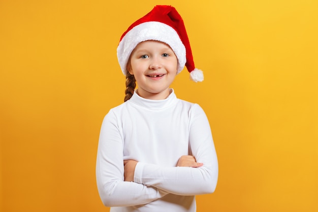 Happy little girl in santa hat.