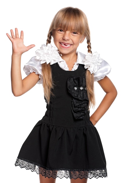 Happy little girl in school uniform isolated on white background