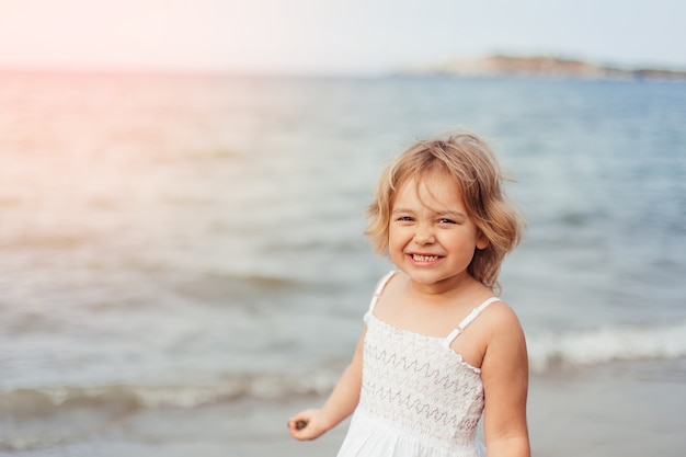 Happy little girl on the sea