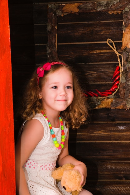 Happy little girl in studio. Village decoration