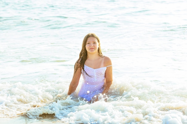 海で遊ぶ水浜の女の子で泳ぐ幸せな少女