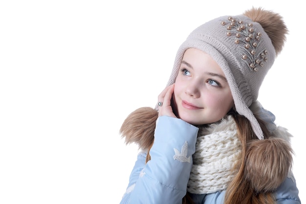 Happy little girl in warm clothes isolated on white background