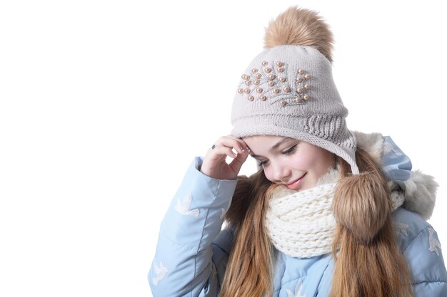 Happy little girl in warm clothes posing isolated on white background