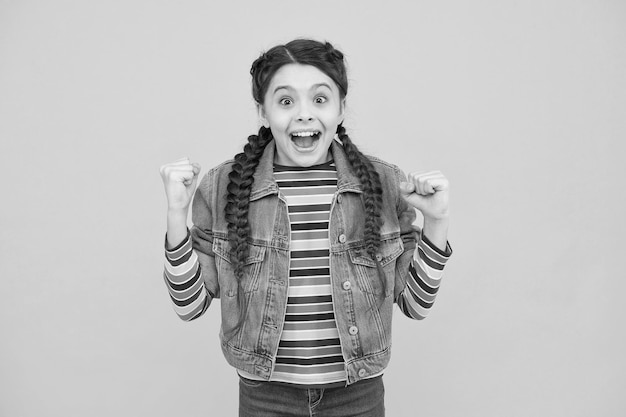 Happy little girl with braids wear denim clothes excited about sale concept