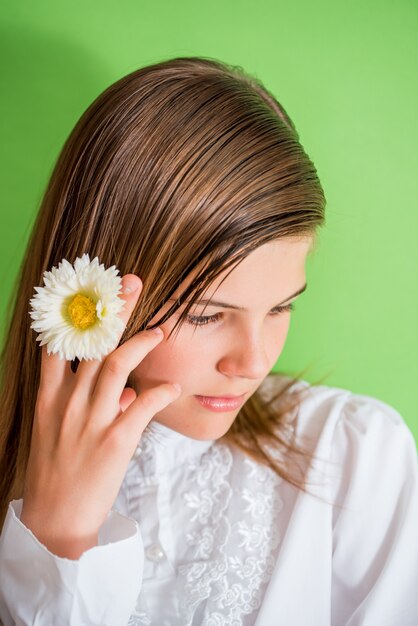 Happy little girl with flower.