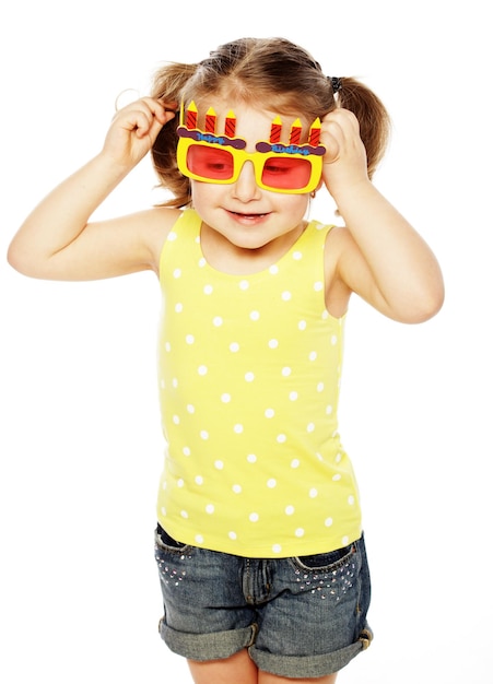 Happy little girl with fun orange carnaval glasses