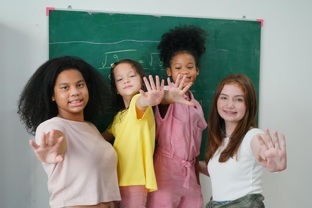 Photo happy little girls against chalkboard with back to school