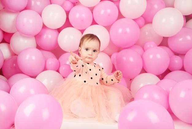 Happy little princess at pink girls party. First birthday