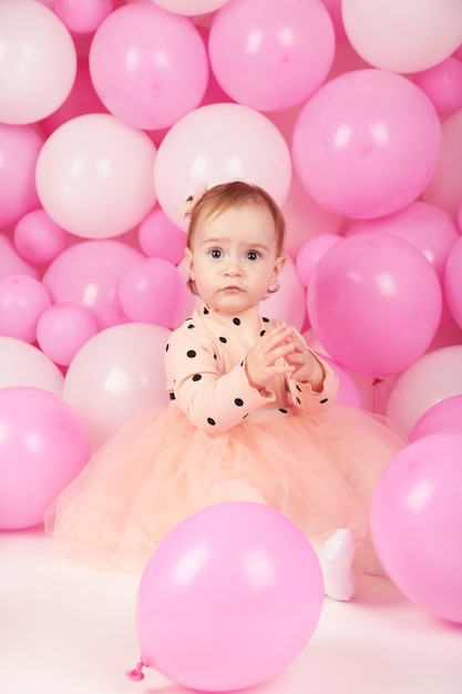 Happy little princess at pink girls party. First birthday