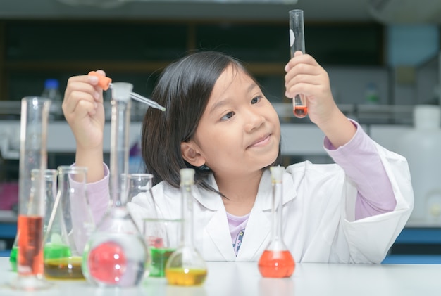 Happy little scientist making experiment 