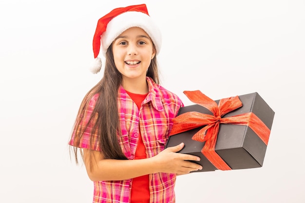 Happy little smiling girl with christmas gift box