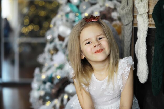 Happy little smiling girl with christmas gift box