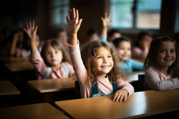 Happy little student girl raising hand up to answer School children in classroom at lesson