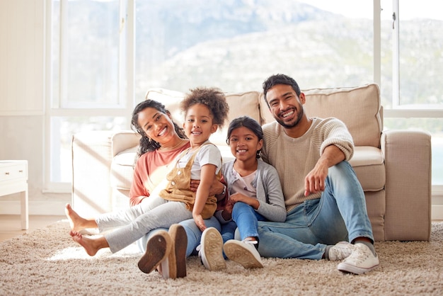 Photo happy love and portrait of a family in the living room sitting on the carpet in their house happiness smile and children relaxing on the floor with their parents in the lounge of a modern home