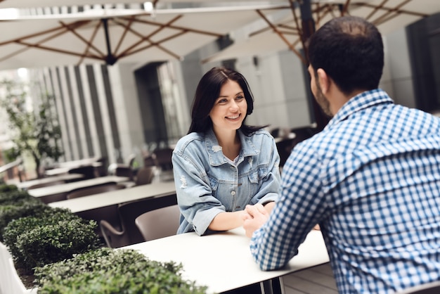 Happy Lovestory Couple in Outdoor Restaurant.