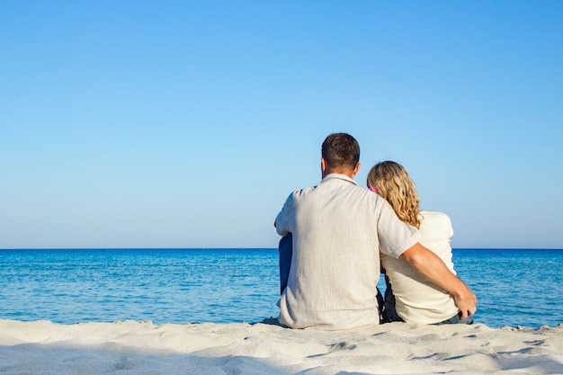 Happy loving couple by the sea in the nature