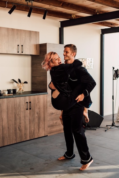 Happy loving couple dancing at home in pajamas