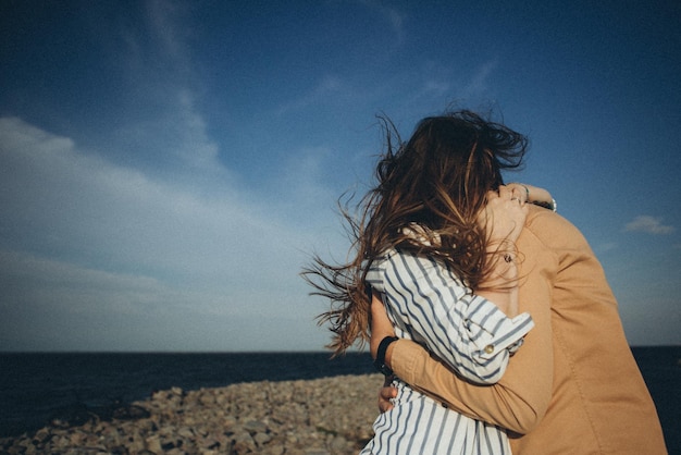 Happy loving couple on a lake beach