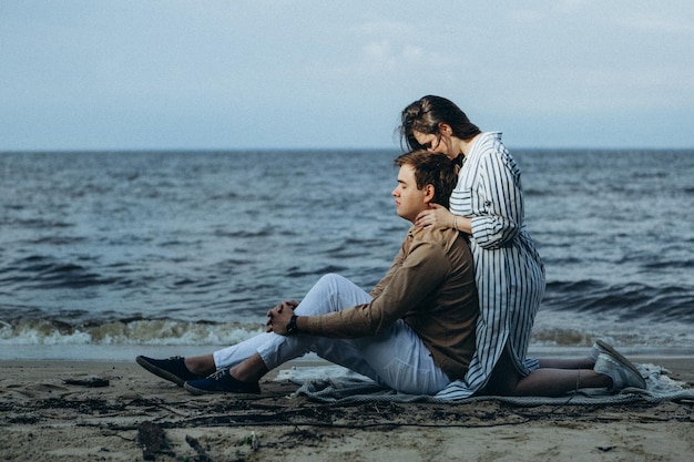 Happy loving couple on a lake beach