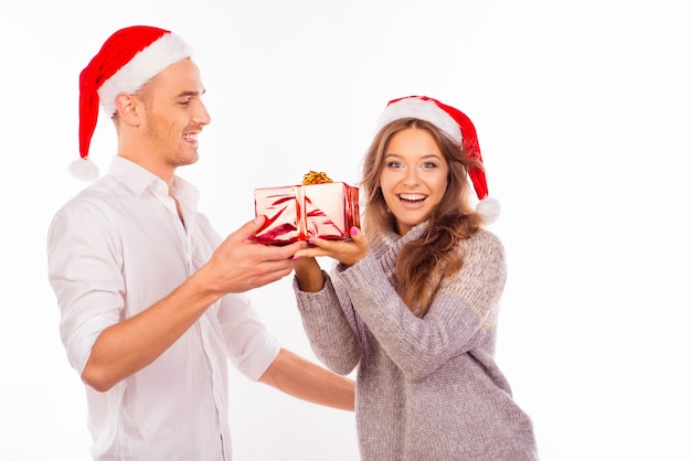 Happy loving couple with Santa hats