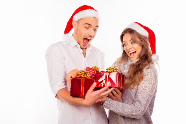 Happy loving couple with Santa hats