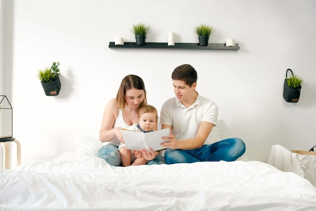 Happy loving family. pretty young mother and ded reading a book to her daughters