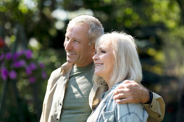 Happy loving senior spouses embracing and enjoying warm spring days spending time together outdoors