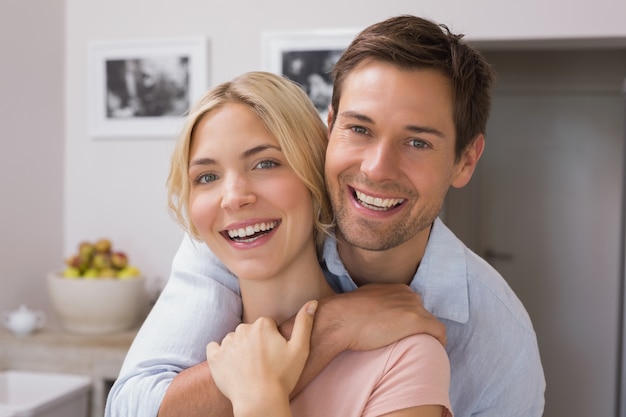 Happy loving young couple in the kitchen