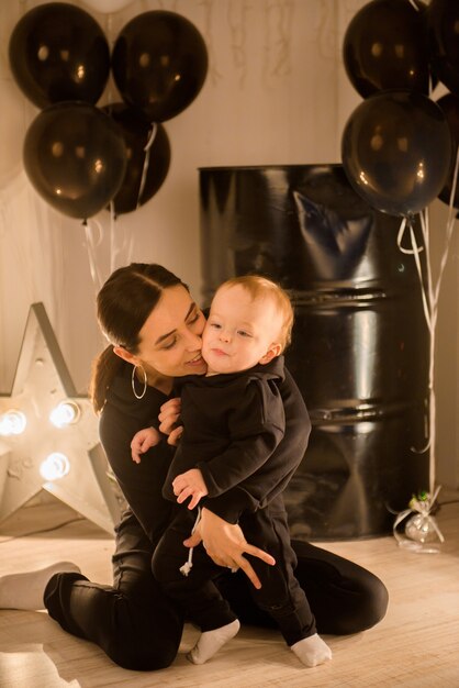 Happy loving young mother kisses her toddler son.