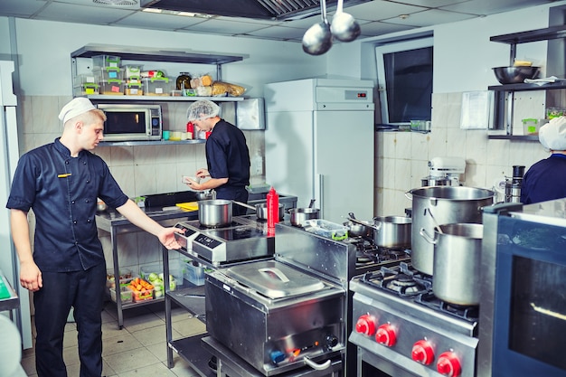 Happy male chef cooking food at restaurant kitchen