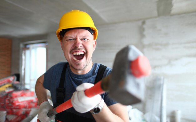 Happy male excited to start building worker hold hammer energetic mood