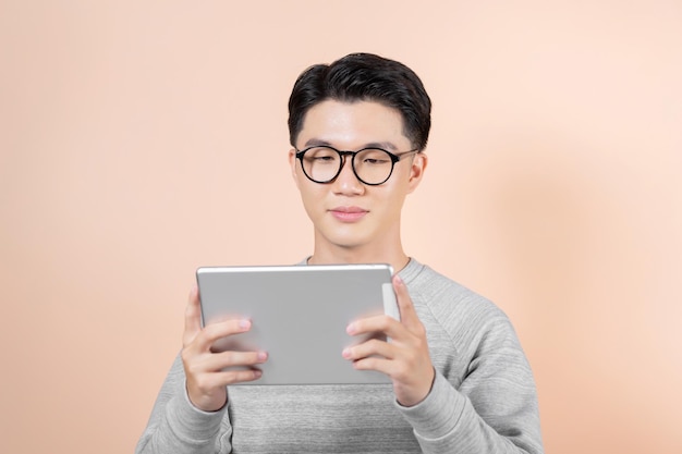 Happy male holding gadget using popular application typing message on screen