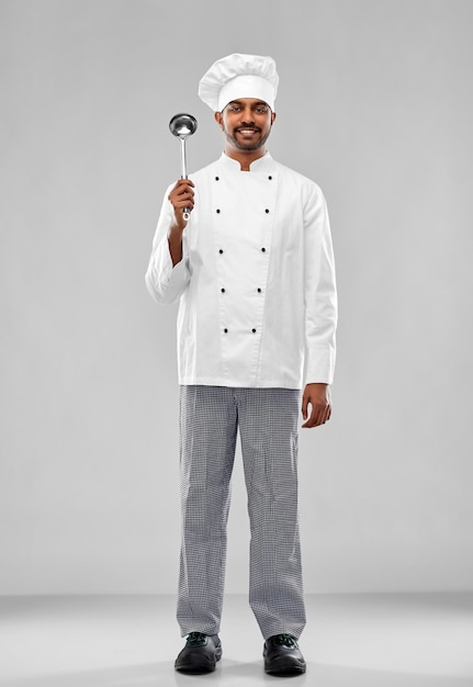 Photo happy male indian chef in toque with ladle