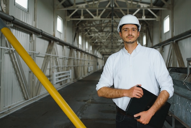 Happy male industrial technician inside a factory