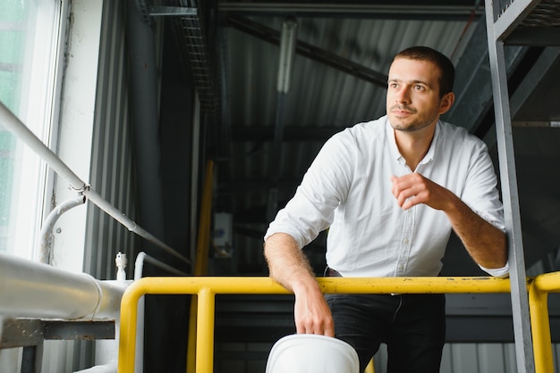 Happy male industrial technician inside a factory