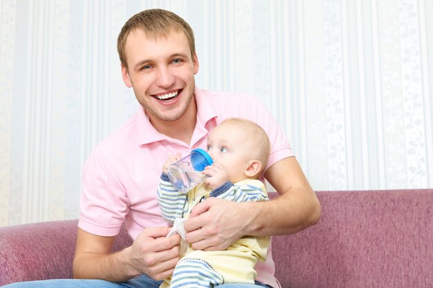 Happy man and baby boy   at home