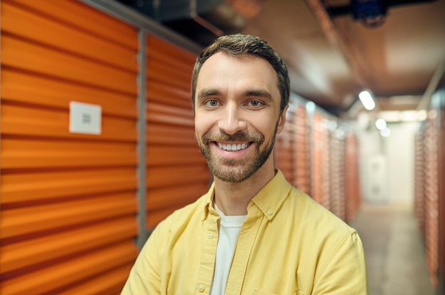 Photo happy man in basement near boxes