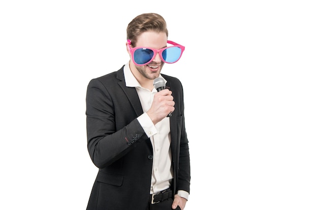 Happy man business speaker in formal suit and funny glasses speak to microphone isolated on white emcee