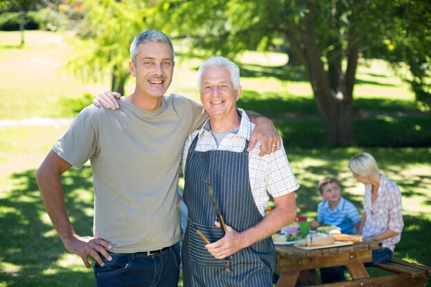 Happy man doing barbecue with his father 