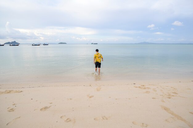 A happy man enjoying and relaxing on the beach