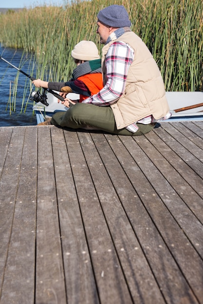 Happy man fishing with his son