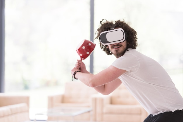 Happy man getting experience using vr-headset glasses of virtual reality at home