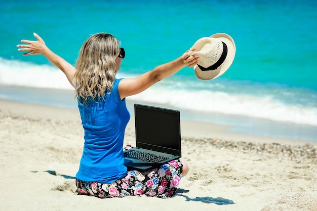 A Happy man girl with laptop near the seaside weekend travel